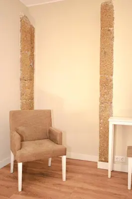 a chair sitting in a room next to a fireplace at Hotel Solar Bom Jesus in Santa Cruz
