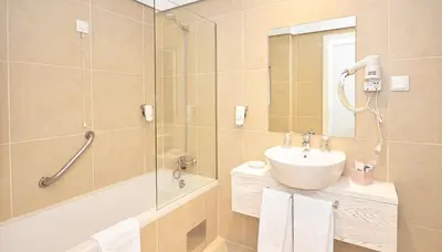 a bathroom with a shower and a sink and a mirror at Hotel Solar Bom Jesus in Santa Cruz