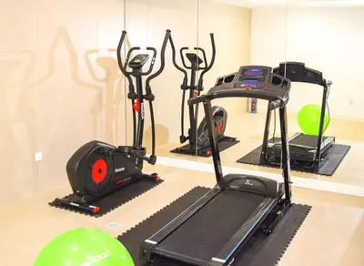 a gym with exercise bikes and a treadmill at Hotel Solar Bom Jesus in Santa Cruz