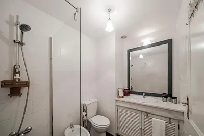 a bathroom with a toilet and a sink and a mirror at Varandas do Funchal II by An Island Apart in Funchal