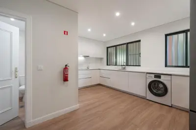 a white kitchen with a washing machine and a sink at Varandas do Funchal II by An Island Apart in Funchal