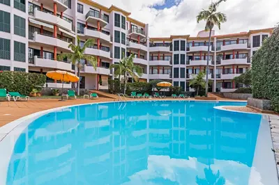 a large swimming pool in front of a building at Varandas do Funchal II by An Island Apart in Funchal