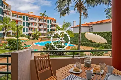 a balcony with a table and a view of a resort at Varandas do Funchal II by An Island Apart in Funchal