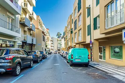a street with cars parked on the side of the road at Holiday Home Funchal Center in Funchal