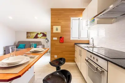 a kitchen with a counter and two stools at Holiday Home Funchal Center in Funchal