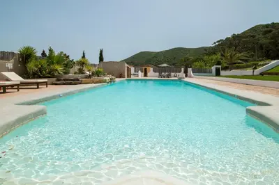 a large swimming pool with blue water at Casa Fajara in Carrapateira