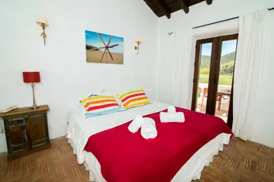 a bedroom with a large bed with towels on it at Casa Fajara in Carrapateira