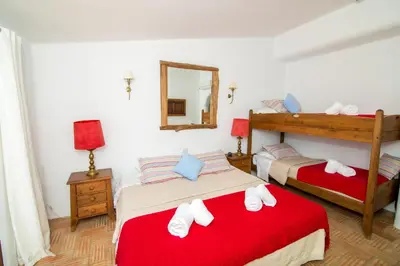 a bedroom with two beds and a mirror at Casa Fajara in Carrapateira