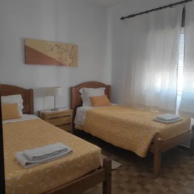 two beds in a room with two beds sidx sidx sidx at Casa Furtado in Burgau