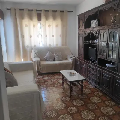 a living room with a couch and a tv at Casa Furtado in Burgau