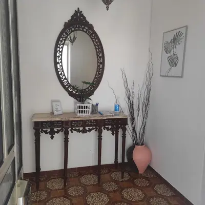 a dressing table with a mirror and a vase at Casa Furtado in Burgau