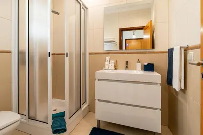 a bathroom with a sink and a shower at Casa Agrela by Rent2U, Lda Swimming Pool & Jacuzzi in Calheta