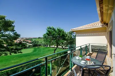 a patio with a table and chairs on a balcony at Luz casas- 44 Fairview village Boavista in Lagos