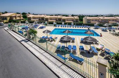 an overhead view of a pool with umbrellas and chairs at Luz casas- 44 Fairview village Boavista in Lagos