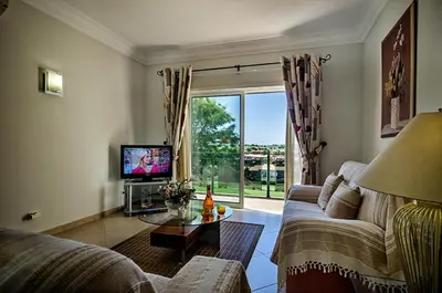 a living room with a couch and a television at Luz casas- 44 Fairview village Boavista in Lagos