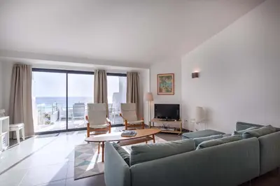 a living room with a couch and a table at Beco Do Poço in Luz