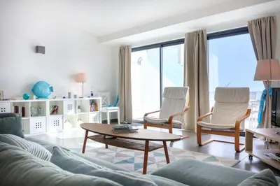 a living room with a couch and chairs and a table at Beco Do Poço in Luz