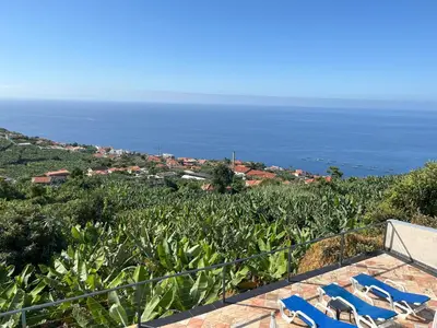 a dining room table with a tableasteryasteryasteryasteryasteryasteryasteryasteryastery at Casa Vista do Ledo in Arco da Calheta