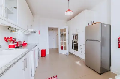 a kitchen with white cabinets and a refrigerator at Funchal Old Town Apartments 2.8 in Funchal