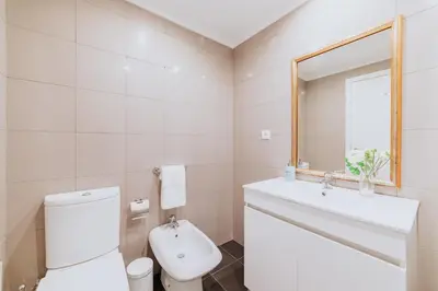 a bathroom with a toilet and a sink and a mirror at Funchal Old Town Apartments 2.8 in Funchal