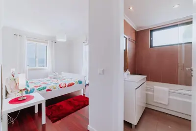 a bedroom with a bed and a tub and a sink at Funchal Old Town Apartments 2.8 in Funchal