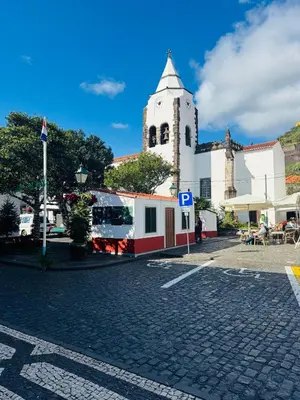 a shadow of a park with red benches on a sidewalk at Residencial Santo António in Santa Cruz