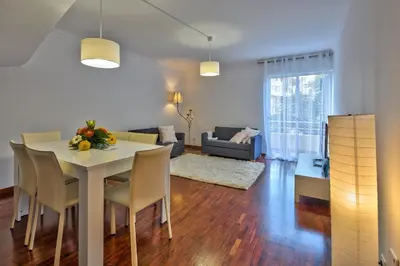 a dining room and living room with a table and chairs at Golden Place Apartment in Funchal