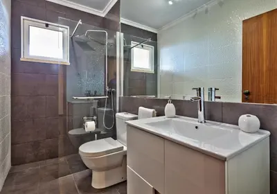 a bathroom with a white sink and a toilet at Golden Place Apartment in Funchal