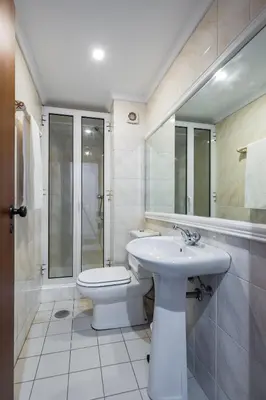 a white bathroom with a toilet and a sink at Golden Place Apartment in Funchal