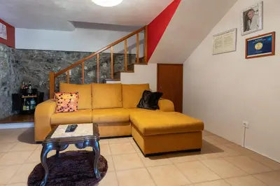 a living room with a couch and a table at Casa do Avo in Arco da Calheta