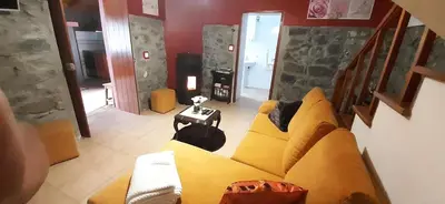 a view of a living room with a yellow couch at Casa do Avo in Arco da Calheta