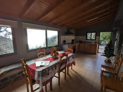 a kitchen and dining room with a table and chairs at Casa do Avo in Arco da Calheta