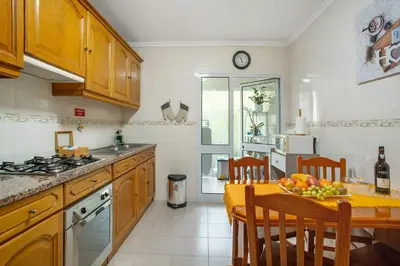 a kitchen with a table with a bowl of fruit on it at Madeira Funchal Gardens in Funchal