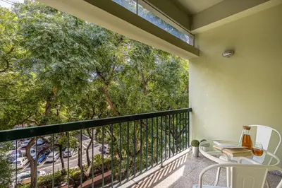 a balcony with a table and chairs and trees at Flat with Balcony at Downtown by Farmers Market in Funchal
