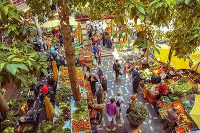 a group of people walking around a farmers market at Flat with Balcony at Downtown by Farmers Market in Funchal