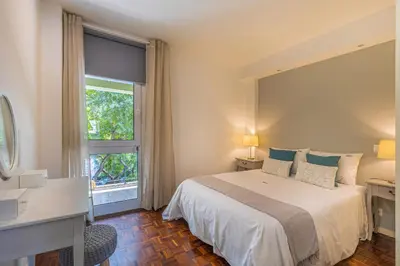 a bedroom with a large bed and a window at Flat with Balcony at Downtown by Farmers Market in Funchal