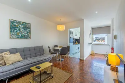 a living room with a couch and a table at Flat with Balcony at Downtown by Farmers Market in Funchal