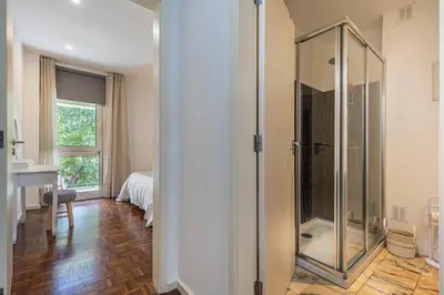 a bathroom with a walk in shower and a sink at Flat with Balcony at Downtown by Farmers Market in Funchal