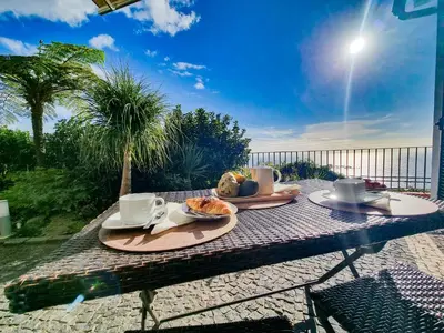 a table with food and coffee on top of it at Casa da Ladeira in Fajã da Ovelha