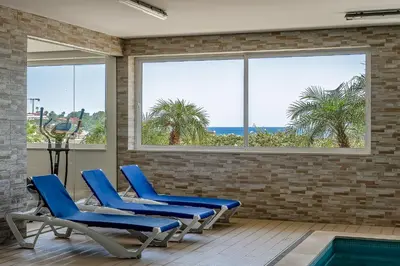 a room with blue chairs and a swimming pool at Porto de Mos Golf & Beach B&B AL-40312 in Lagos