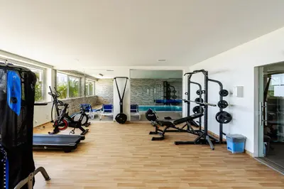 a gym with treadmills and exercise bikes in a room at Porto de Mos Golf & Beach B&B AL-40312 in Lagos
