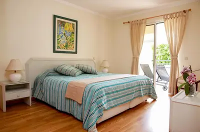 a bedroom with a bed and a sliding glass door at Apartamento Infante in Funchal