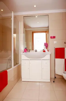 a bathroom with a white sink and a mirror at Apartamento Infante in Funchal