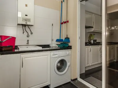 a kitchen with a washing machine and a sink at Apartamento Infante in Funchal