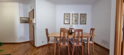 a dining room with a wooden table and chairs at Apartamento Infante in Funchal