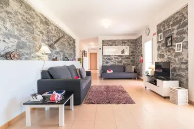 a living room with a couch and a table at Casa Sol e Vista in Arco da Calheta