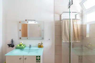 a bathroom with a blue sink and a shower at Casa Sol e Vista in Arco da Calheta