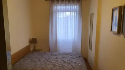 a bedroom with a bed next to a window at Funchal Apartament Marina View with PARKING FREE in Funchal