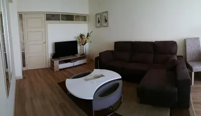 a living room with a couch and a table at Funchal Apartament Marina View with PARKING FREE in Funchal