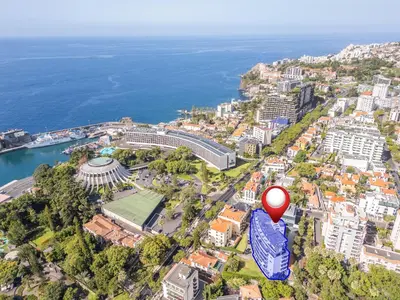 an aerial view of a city with a red balloon at Apartamento Jasmineiro - By WeHost in Funchal